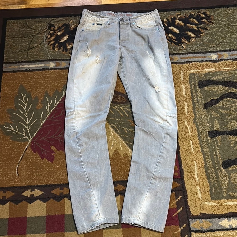 Relaxed Fit Light Blue Jeans with Distressed Design‎